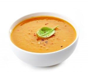 Bowl of squash soup on a white background
